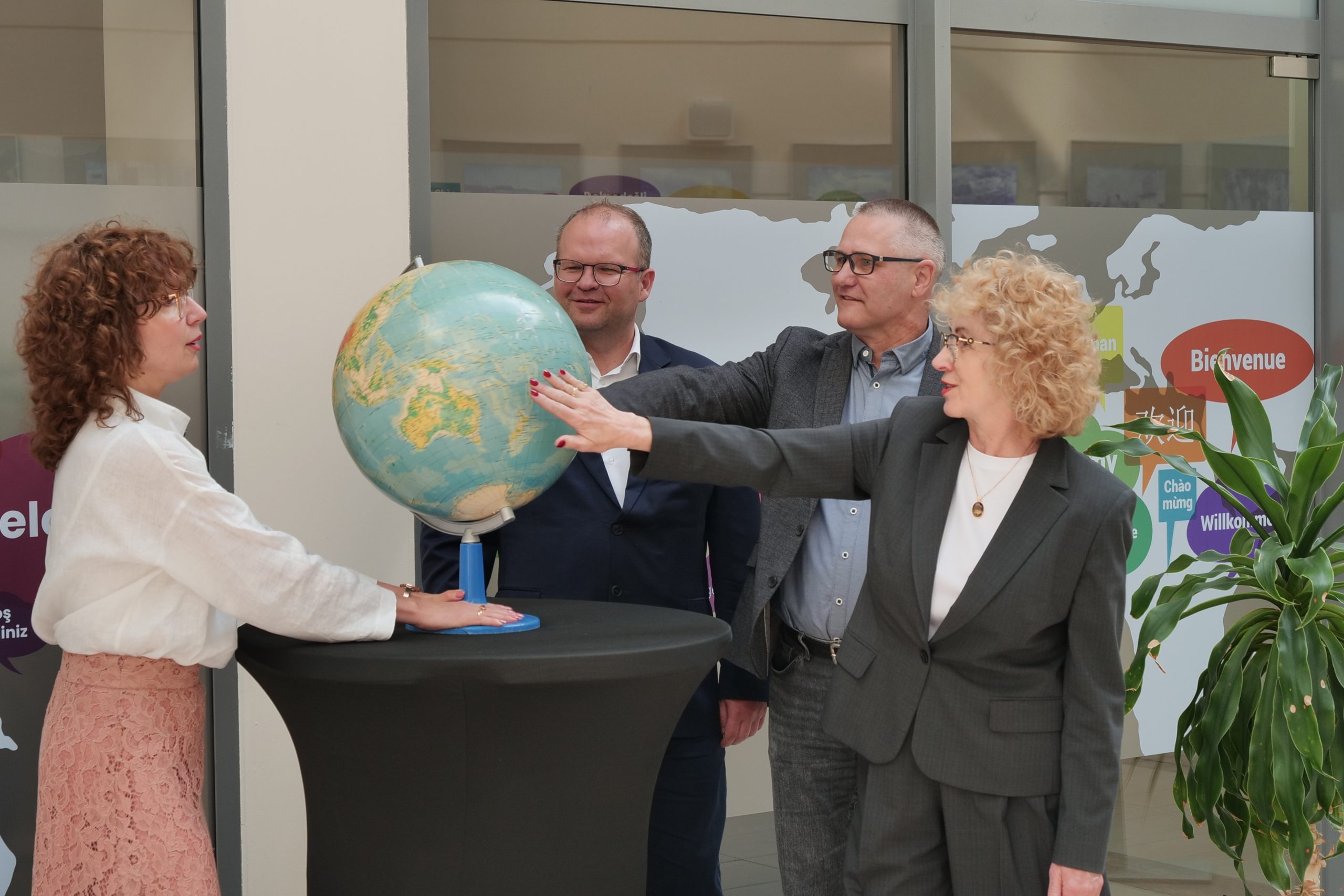University representatives mark the opening of Welcome Centre UJK by turning a globe during the inauguration ceremony.