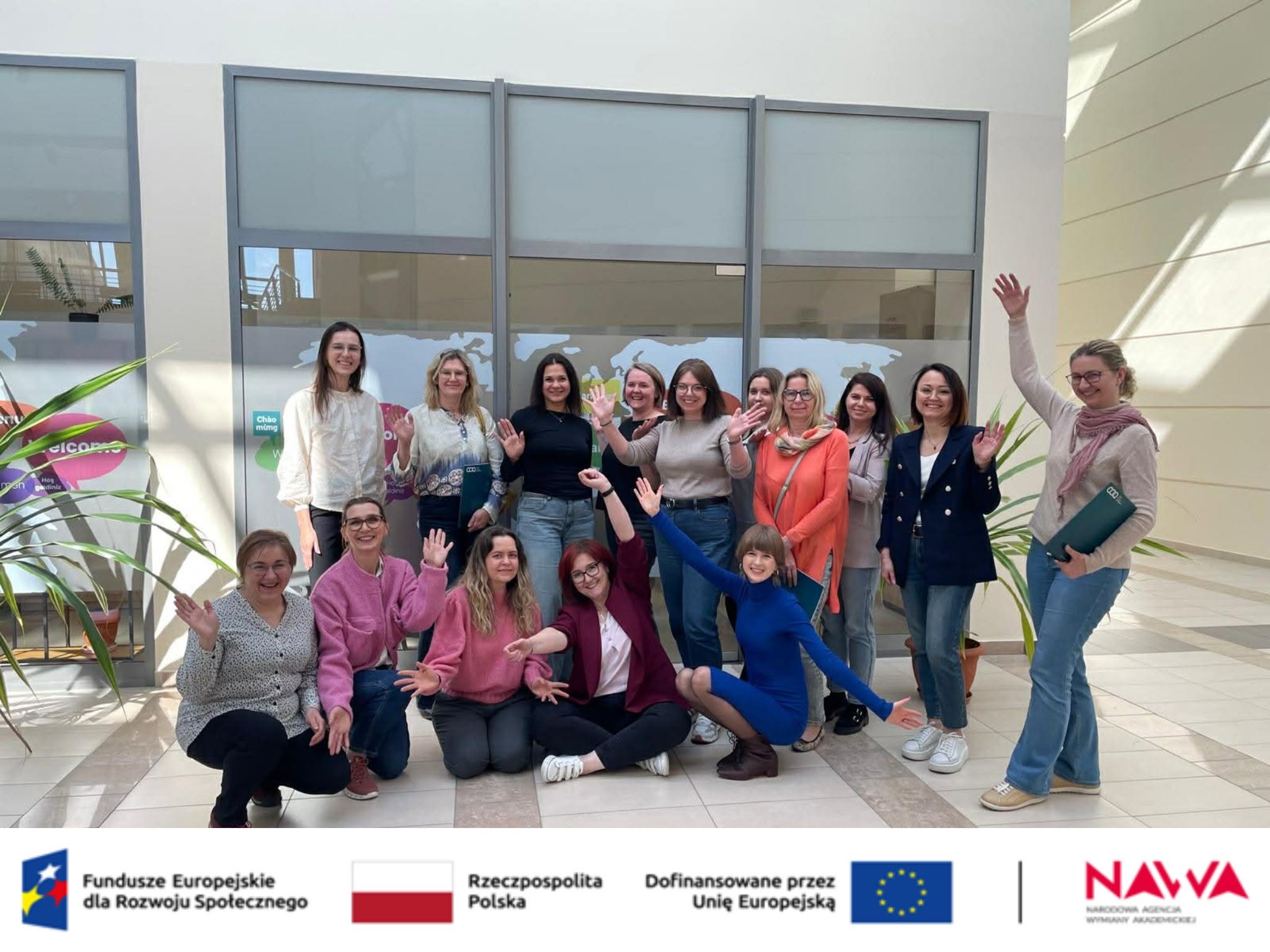 Administrative staff pose for a group photo following an intercultural training session at Jan Kochanowski University of Kielce.