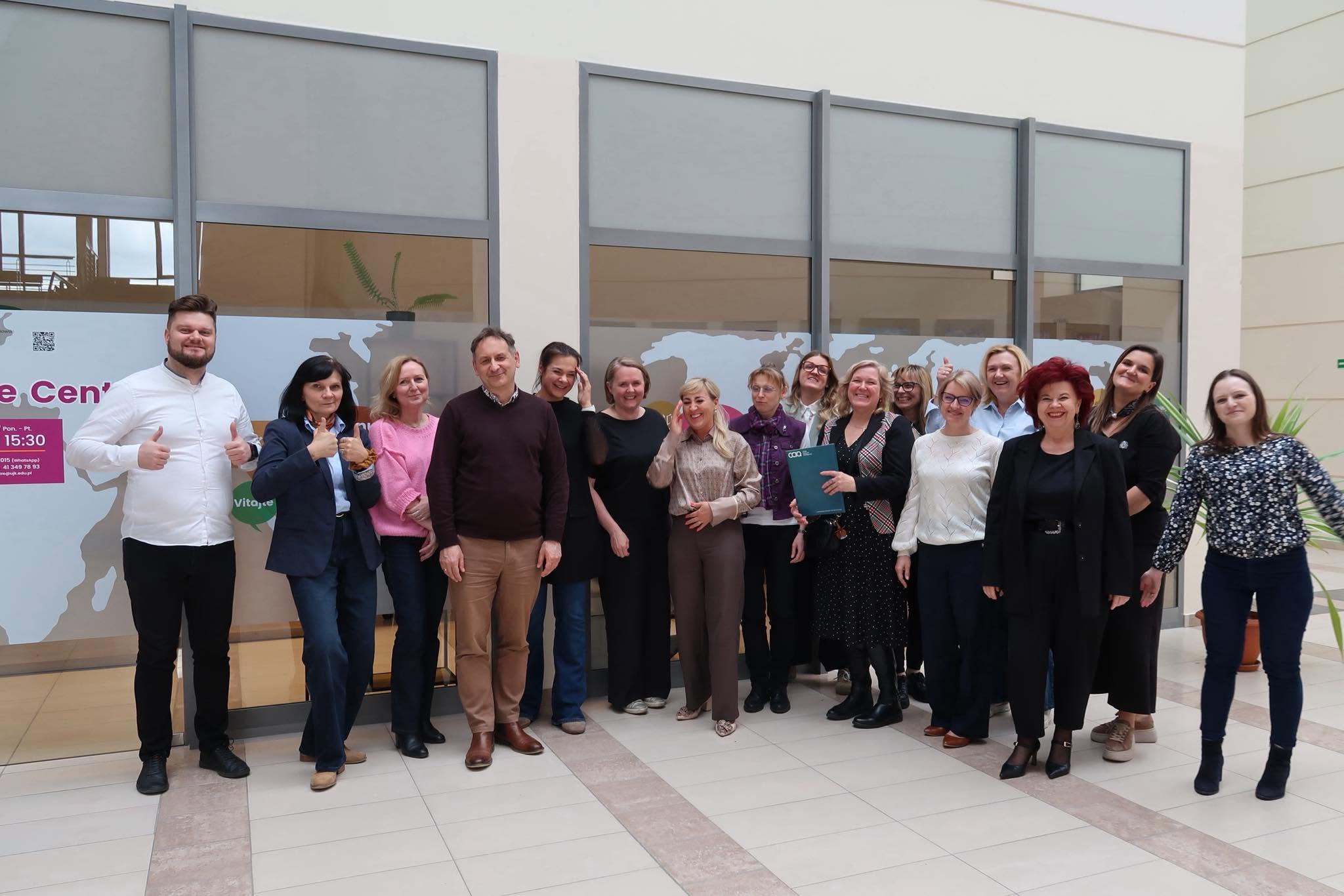 Academic teachers pose together for a group photo after a training session at Jan Kochanowski University of Kielce.